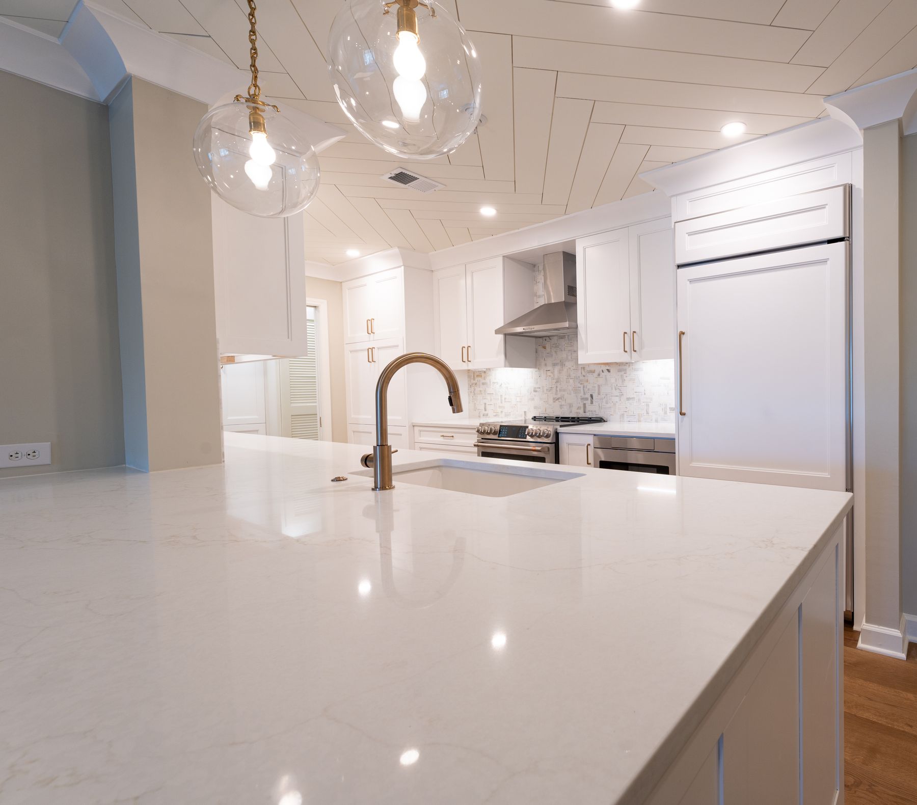 Bright modern kitchen with a polished stone island and countertops